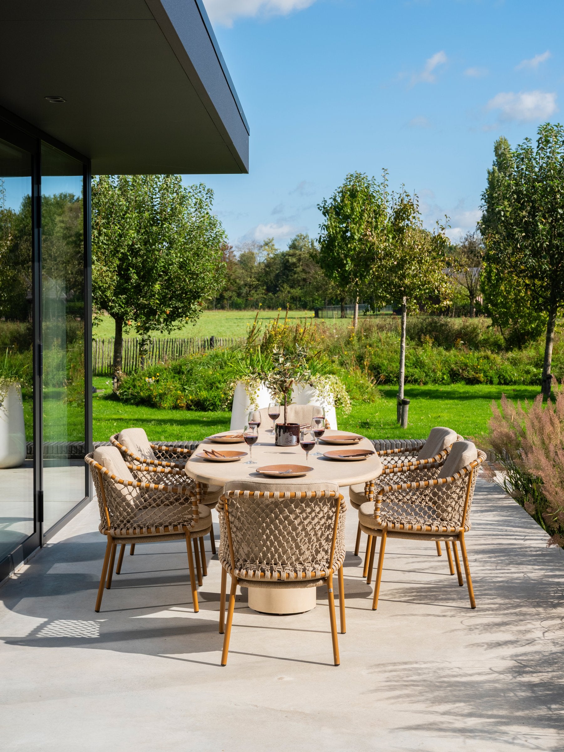 Martinique modular corner lounge set amber with lounge chair and Hampton tables - Lifestyle