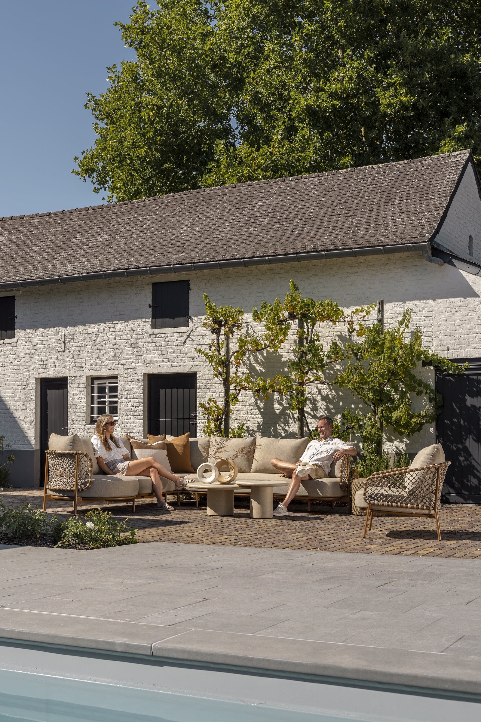 Martinique modular corner lounge set amber with lounge chair and Hampton tables - Lifestyle