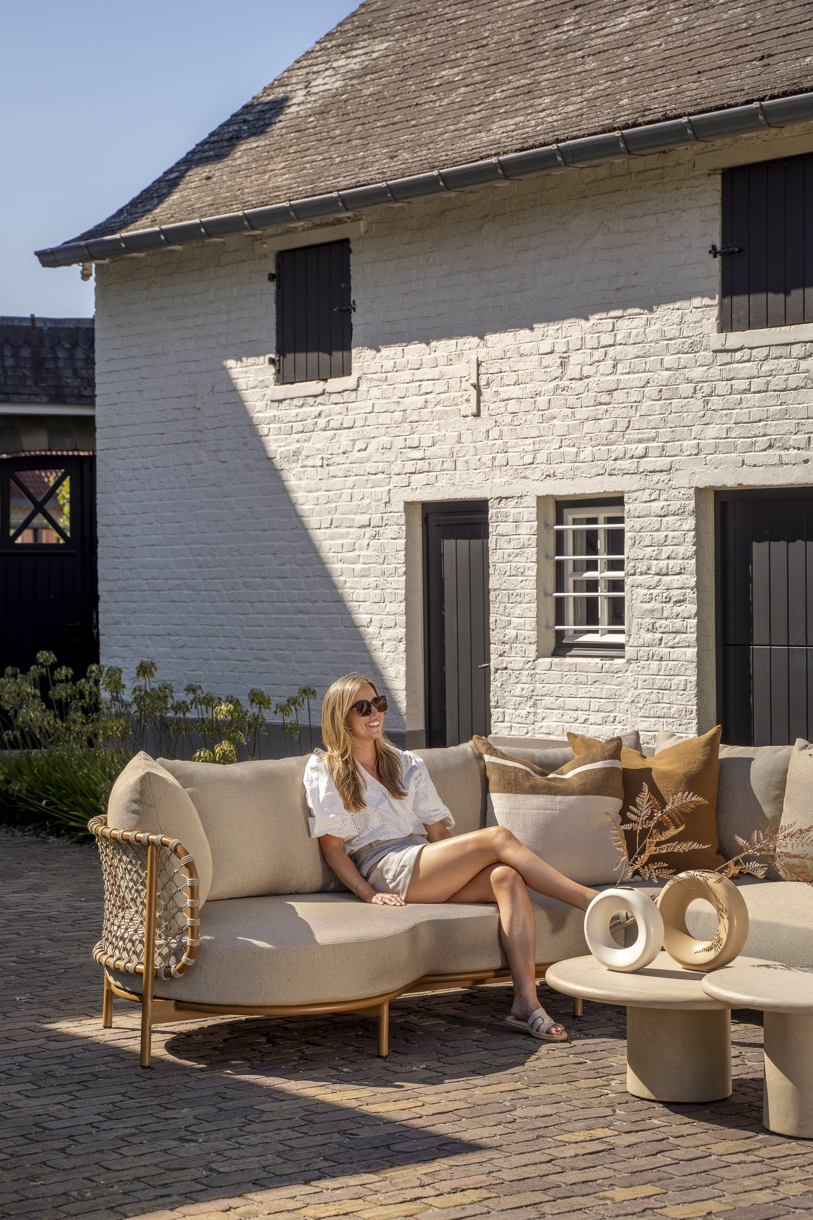 Martinique modular corner lounge set amber with lounge chair and Hampton tables - Lifestyle